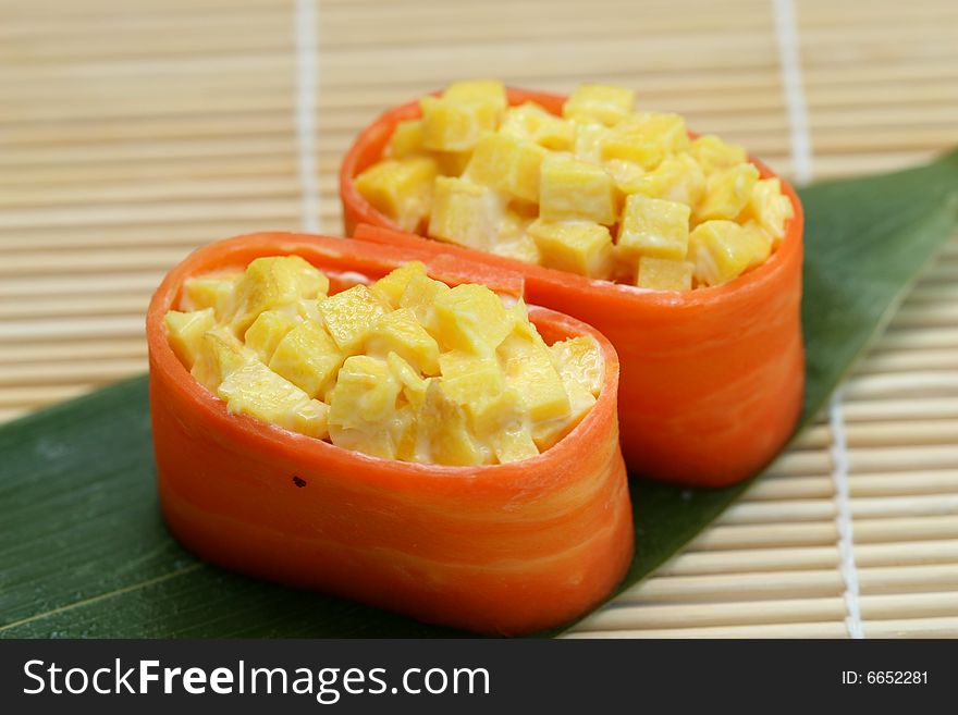 Two pieces of sushi pineapple on the desk