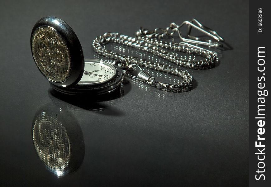 Pocket watch and reflection on grainy glossy surface. Pocket watch and reflection on grainy glossy surface