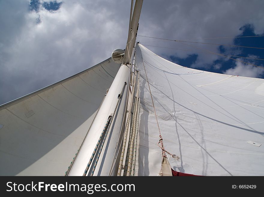 Looking up at sails and mast of boat.