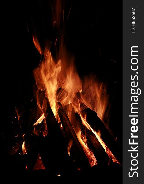 Large blazing campfire against dark night