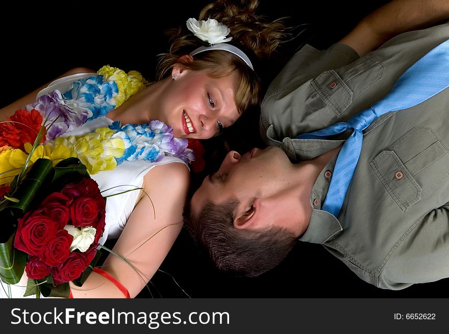 Young happy laughing wedding couple on black background, studio shot. Young happy laughing wedding couple on black background, studio shot