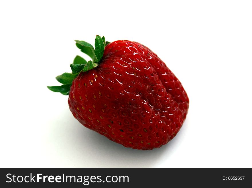 A fresh local organic strawberry. A fresh local organic strawberry
