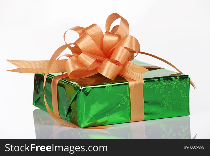 Green present with orange bow and ribbons