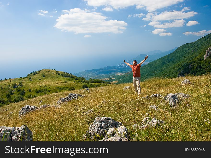 Happy man on a beautiful mountain nature in Crimea, Ukraine. Happy man on a beautiful mountain nature in Crimea, Ukraine