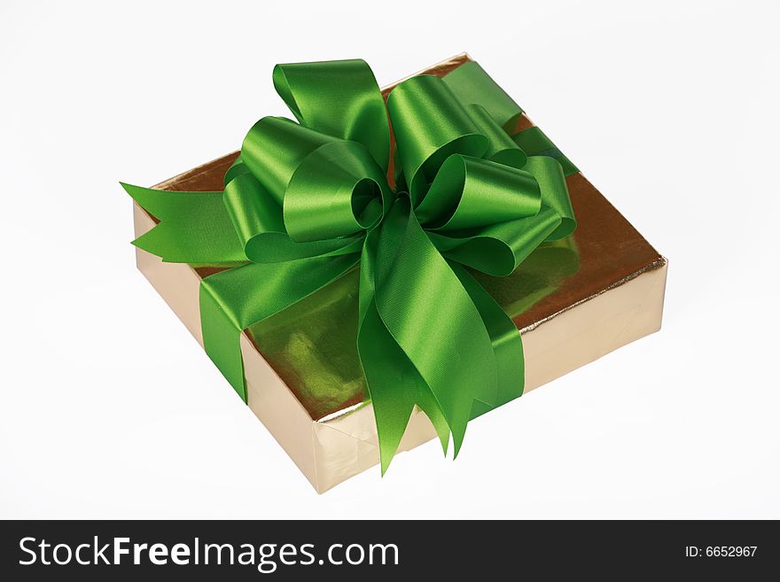 Gold present wrapped with green ribbons