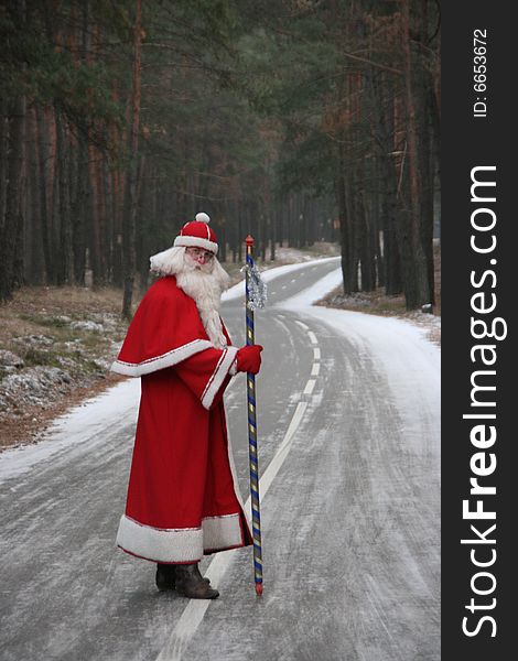 Santa Claus coming along deep forest road. Santa Claus coming along deep forest road