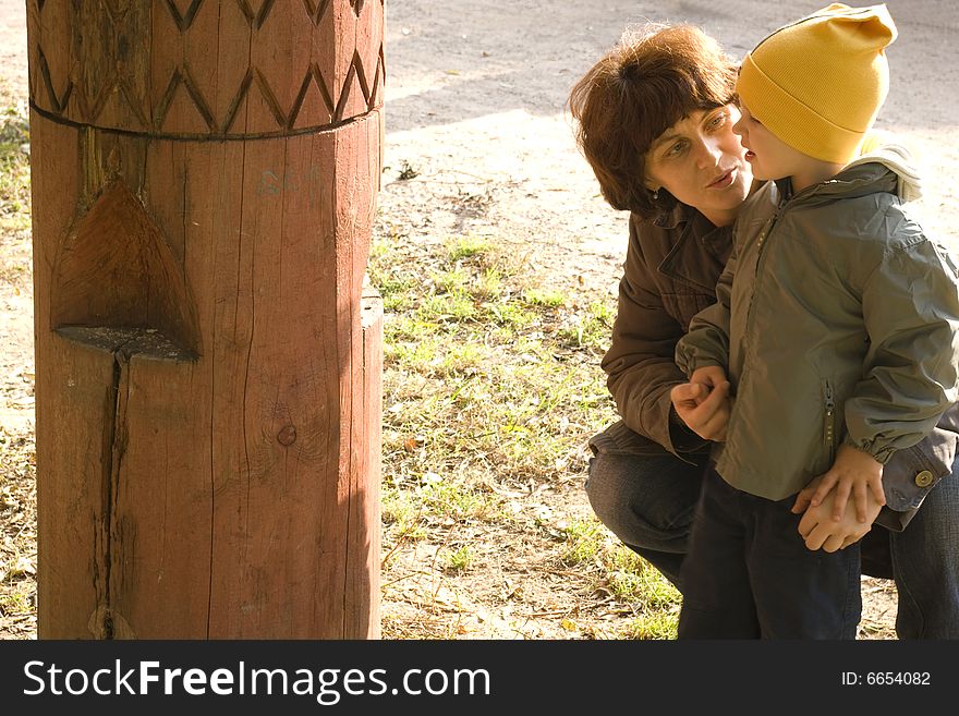 Mom tells son about feeder for the birds. Mom tells son about feeder for the birds