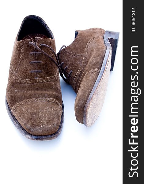 Used brown suede shoes isolated on a white background