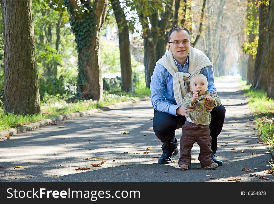 Father and son walking in park during autumn. Father and son walking in park during autumn