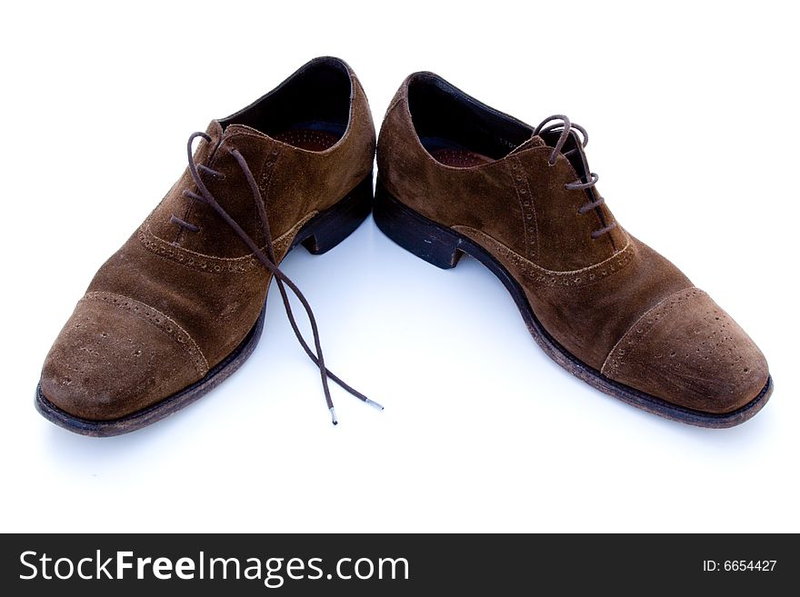 Used brown suede shoes isolated on a white background