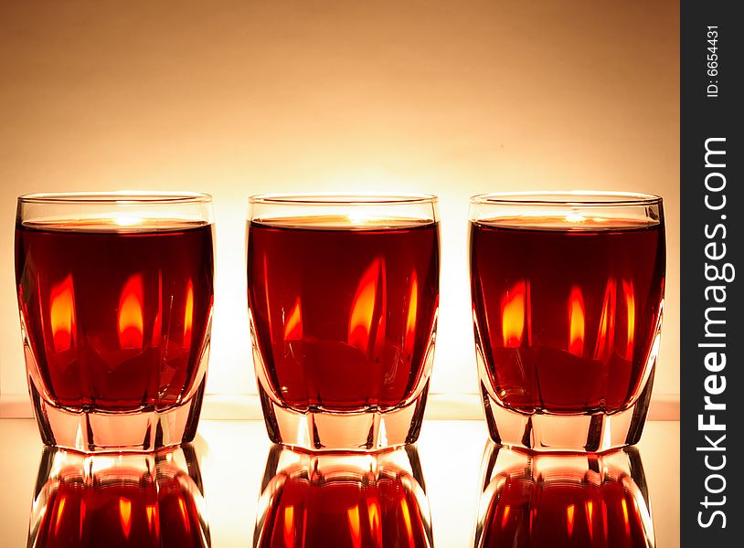 Glasses with red wine and candles