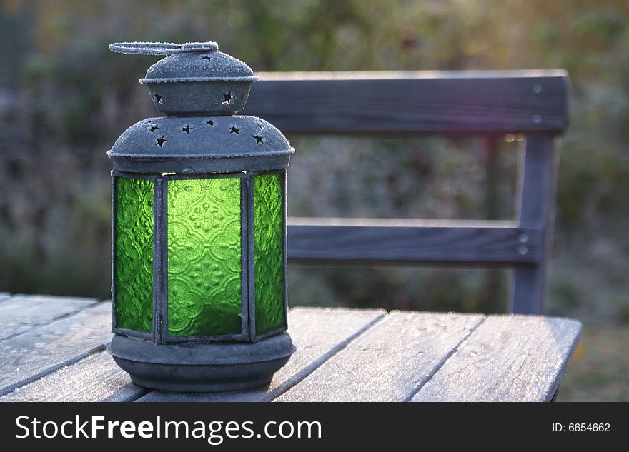 Lantern for candles on a frosty table. Lantern for candles on a frosty table