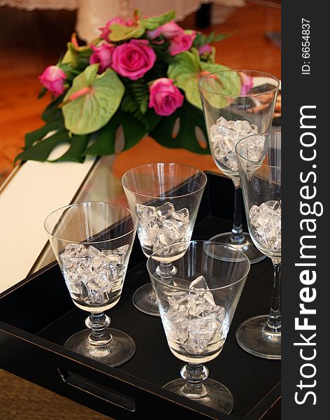 Five glasses with ice and a nice bunch of pink roses. Five glasses with ice and a nice bunch of pink roses