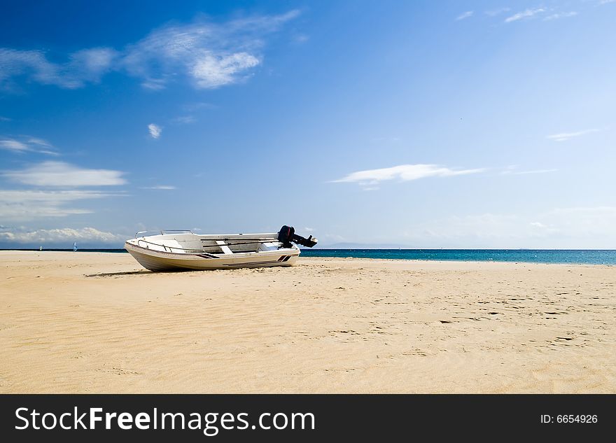 Lonely boat on beautiful beach in Spain. Lonely boat on beautiful beach in Spain