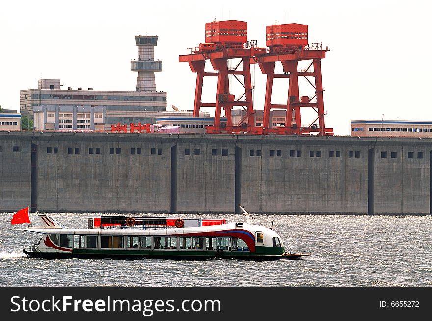 Ship sailing in the reservoir, is the background of the dam and facilities. Ship sailing in the reservoir, is the background of the dam and facilities