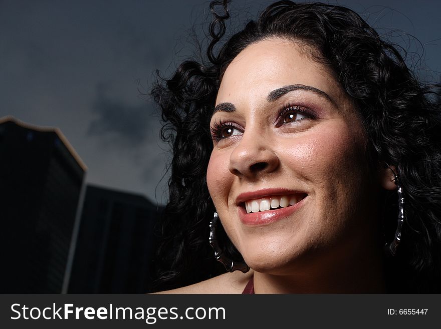 Young female smiling while glancing away. Young female smiling while glancing away