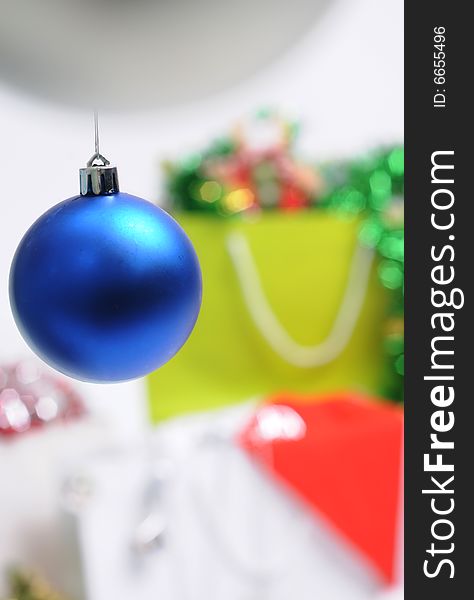 Christmas bauble with present as blur background. Christmas bauble with present as blur background