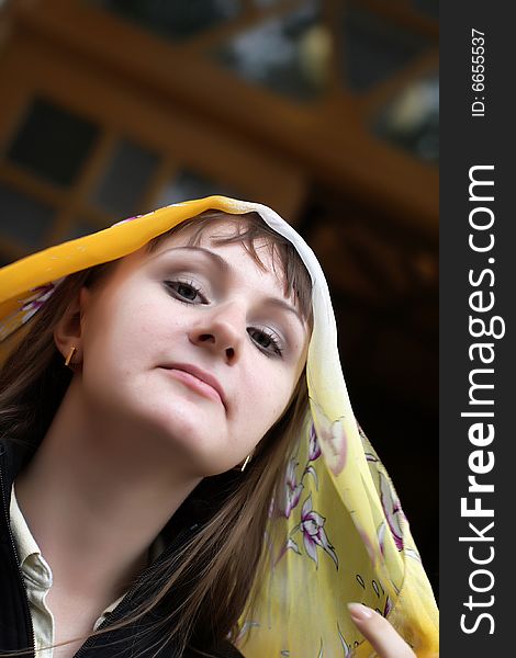 Portrait of brunette girl in yellow kerchief