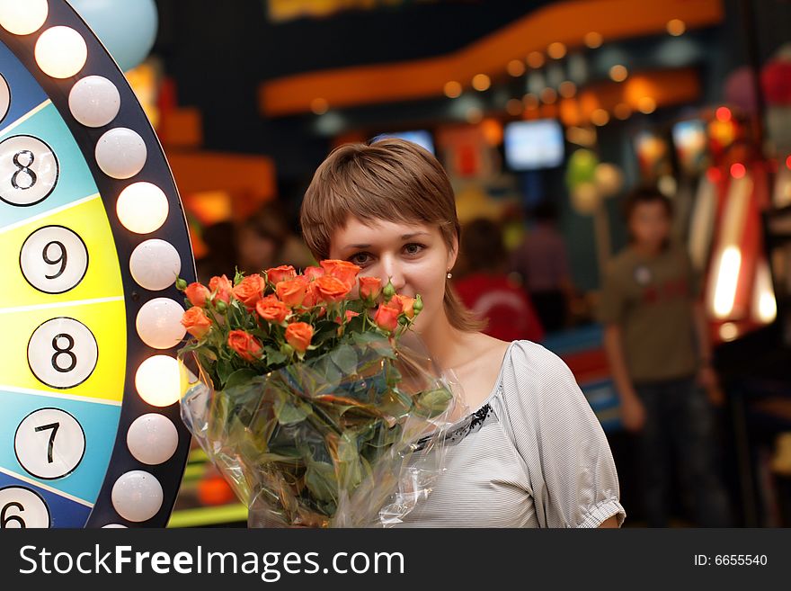 The girl with bunch of flowers in casino. The girl with bunch of flowers in casino