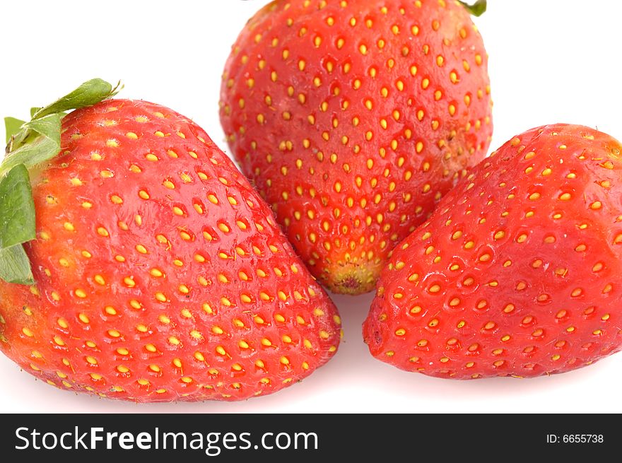 Appetizing brightly red strawberry on a white background. Appetizing brightly red strawberry on a white background