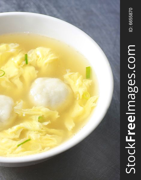 It's asian traditional food. fish ball soup with egg flower and green onion. It's asian traditional food. fish ball soup with egg flower and green onion