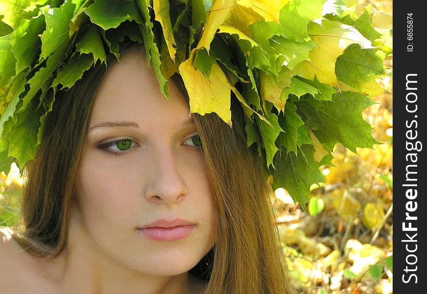 Nice young girl with autumn maple wreath. Nice young girl with autumn maple wreath