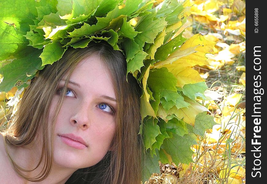 Nice young girl with autumn maple wreath. Nice young girl with autumn maple wreath