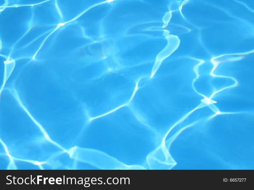 Reflected Light in a Swimming Pool Creates an Abstract Background Image. Reflected Light in a Swimming Pool Creates an Abstract Background Image.