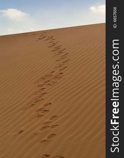 Footprints on a sand dune