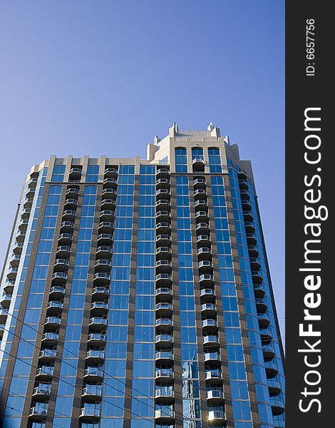 A blue glass apartment tower with balconies. A blue glass apartment tower with balconies
