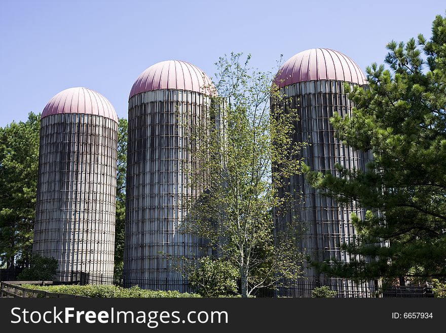 Three old grain silos on a farm. Three old grain silos on a farm