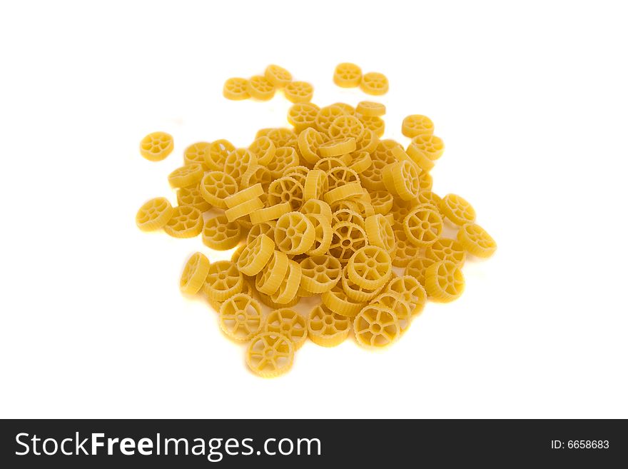 Raw wheels macaroni isolated on a white background. Raw wheels macaroni isolated on a white background