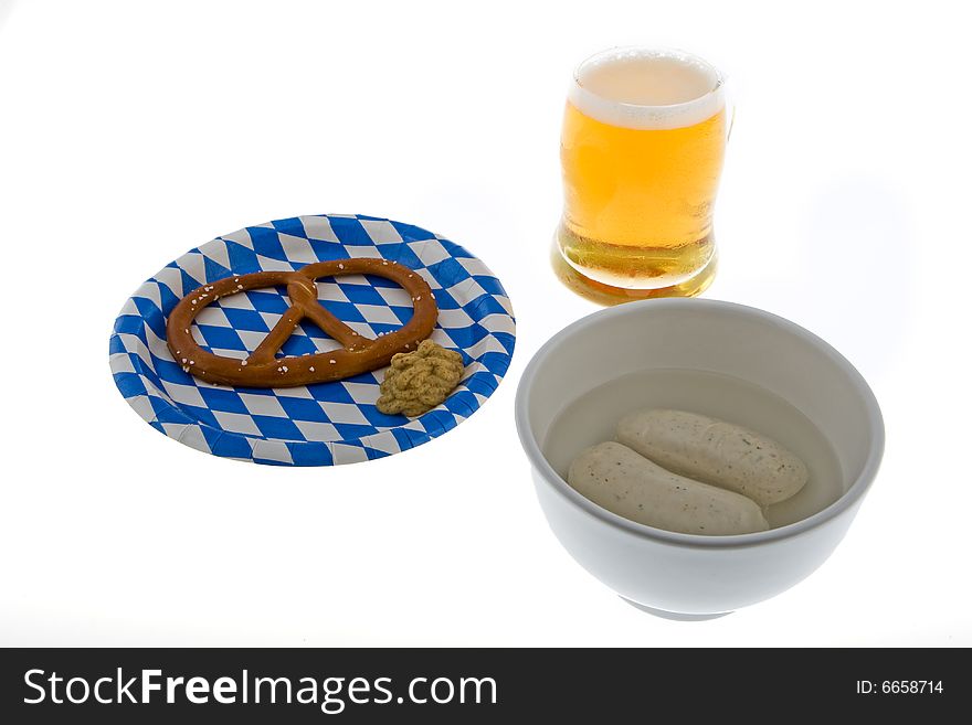Munich October celebration with beer, cracknel and veal sausage against a white background