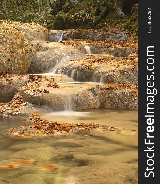 Autumn scenic water stream in the forest. Autumn scenic water stream in the forest