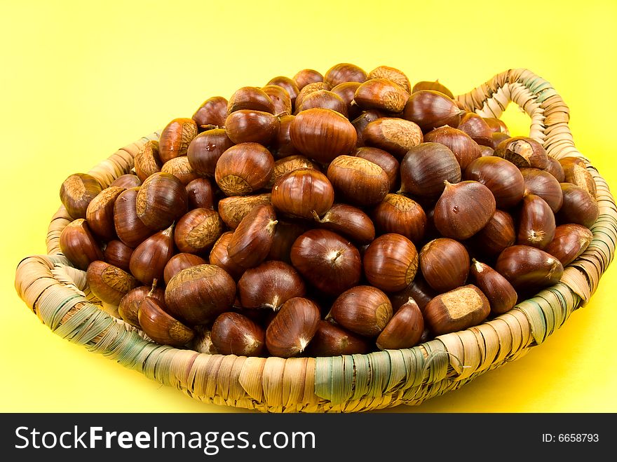 Many Ripe Chestnuts On Yellow Background