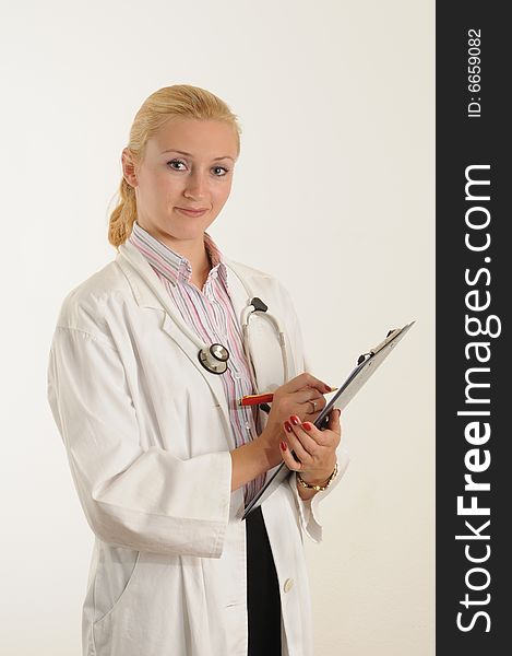 Female medical doctor working with her clipboard. Using a Stethoscope. Female medical doctor working with her clipboard. Using a Stethoscope.