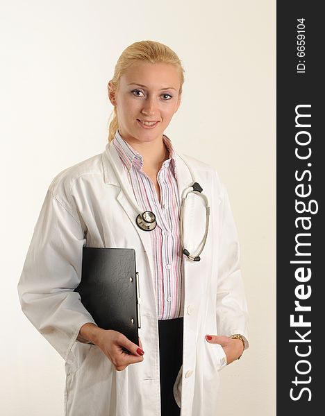 Female medical doctor working with her clipboard. Using a Stethoscope. Female medical doctor working with her clipboard. Using a Stethoscope.