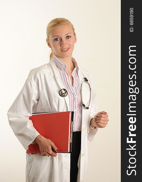 Female medical doctor working with her clipboard. Using a Stethoscope. Female medical doctor working with her clipboard. Using a Stethoscope.