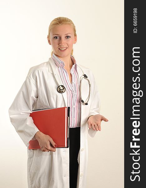 Female medical doctor working with her clipboard. Using a Stethoscope. Female medical doctor working with her clipboard. Using a Stethoscope.