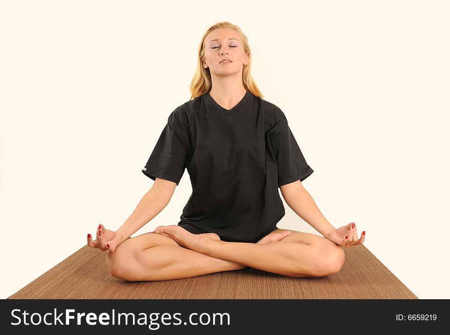 Young woman concentrating on yoga exercise,isolated.