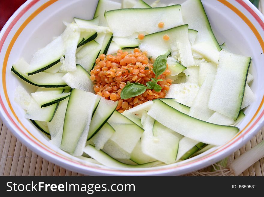 A salad of fresh zucchinis with red lentils