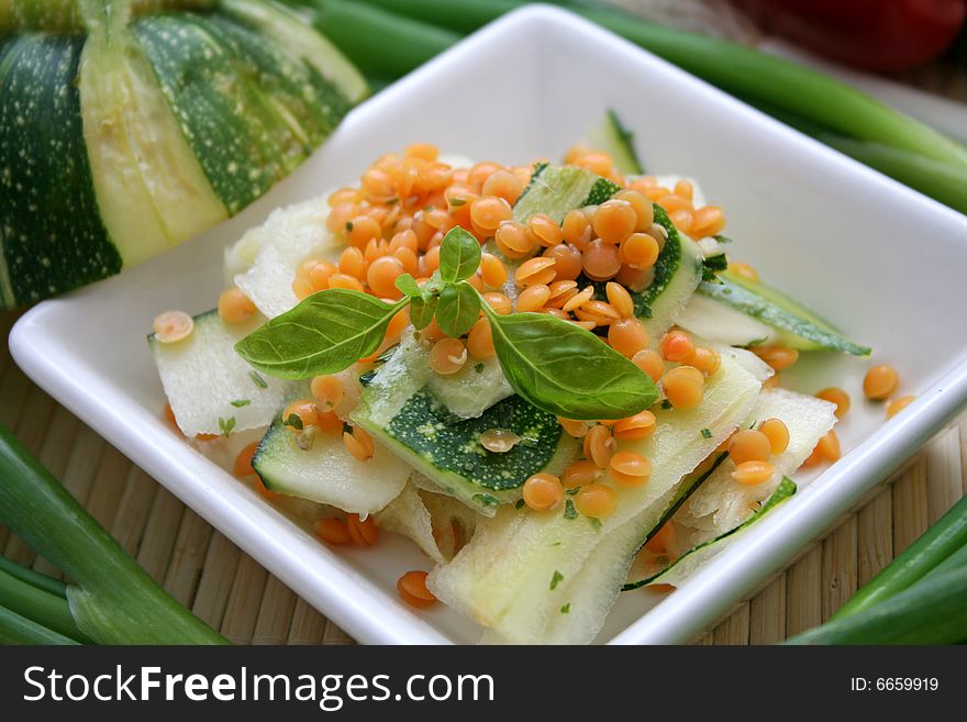A fresh salad of zucchini with red lentils