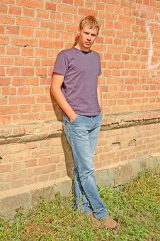 Young Stylish Man Stand Near Brick Wall. Stock Photo Young Stylish Man Stand Near Brick Wall. Stock Photo