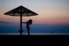 Umbrella And The Girl On A Beach. Evening Royalty Free Stock Photography Umbrella And The Girl On A Beach. Evening Royalty Free Stock Photography