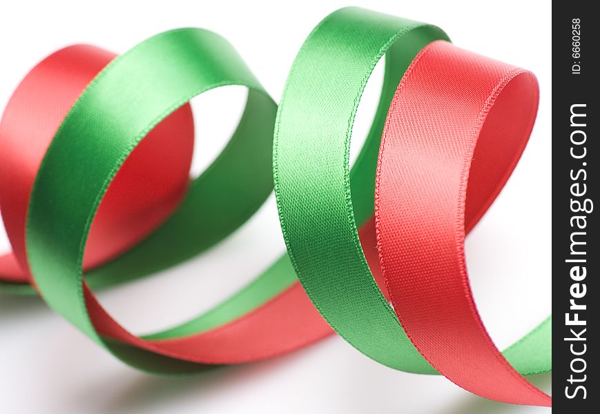 Red and green ribbon curling on white