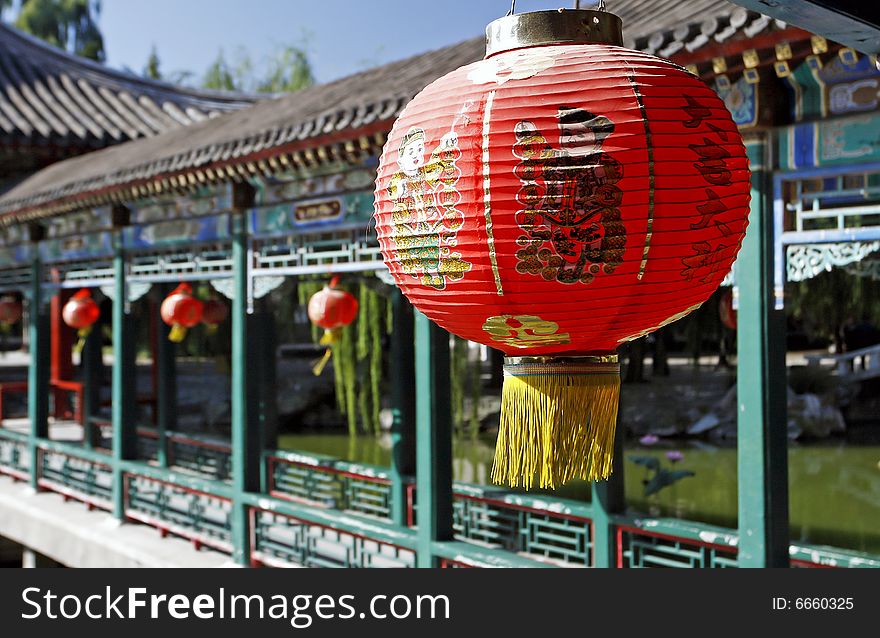 Red lantern on the ancient garden long corridor of China. Chinese on the lantern is that a good luck is lucky.