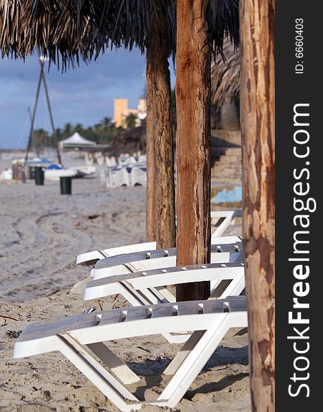 Chaises on the long caribbean beach. Chaises on the long caribbean beach