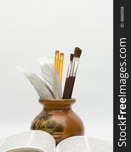 Vase and book on white background