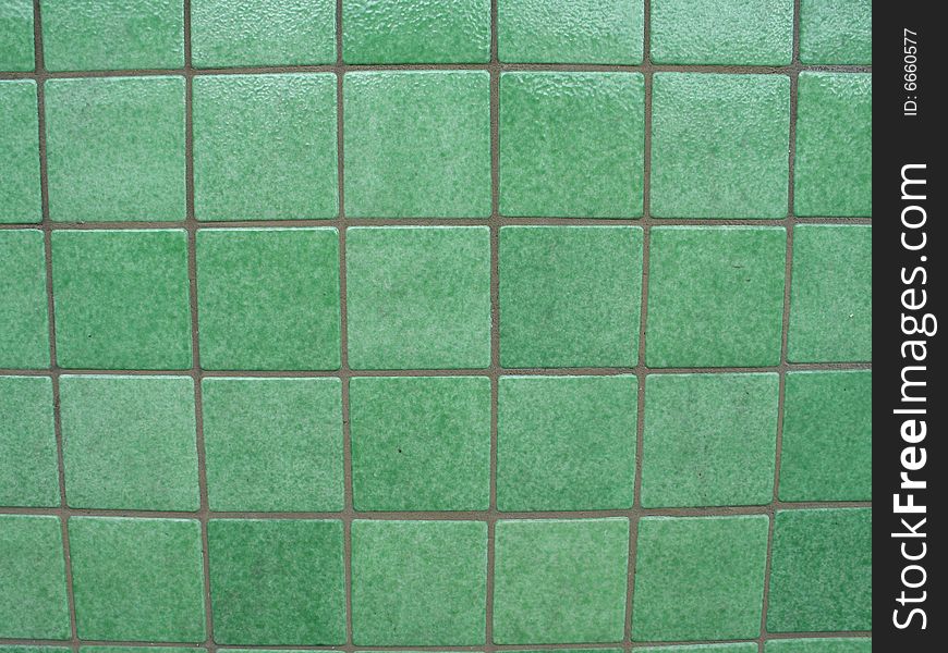 Green tiled background with grey grout