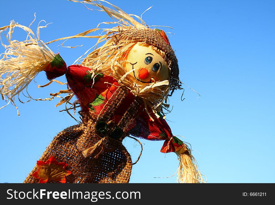 A scarecrow dressed in burlap made with straw. A scarecrow dressed in burlap made with straw.